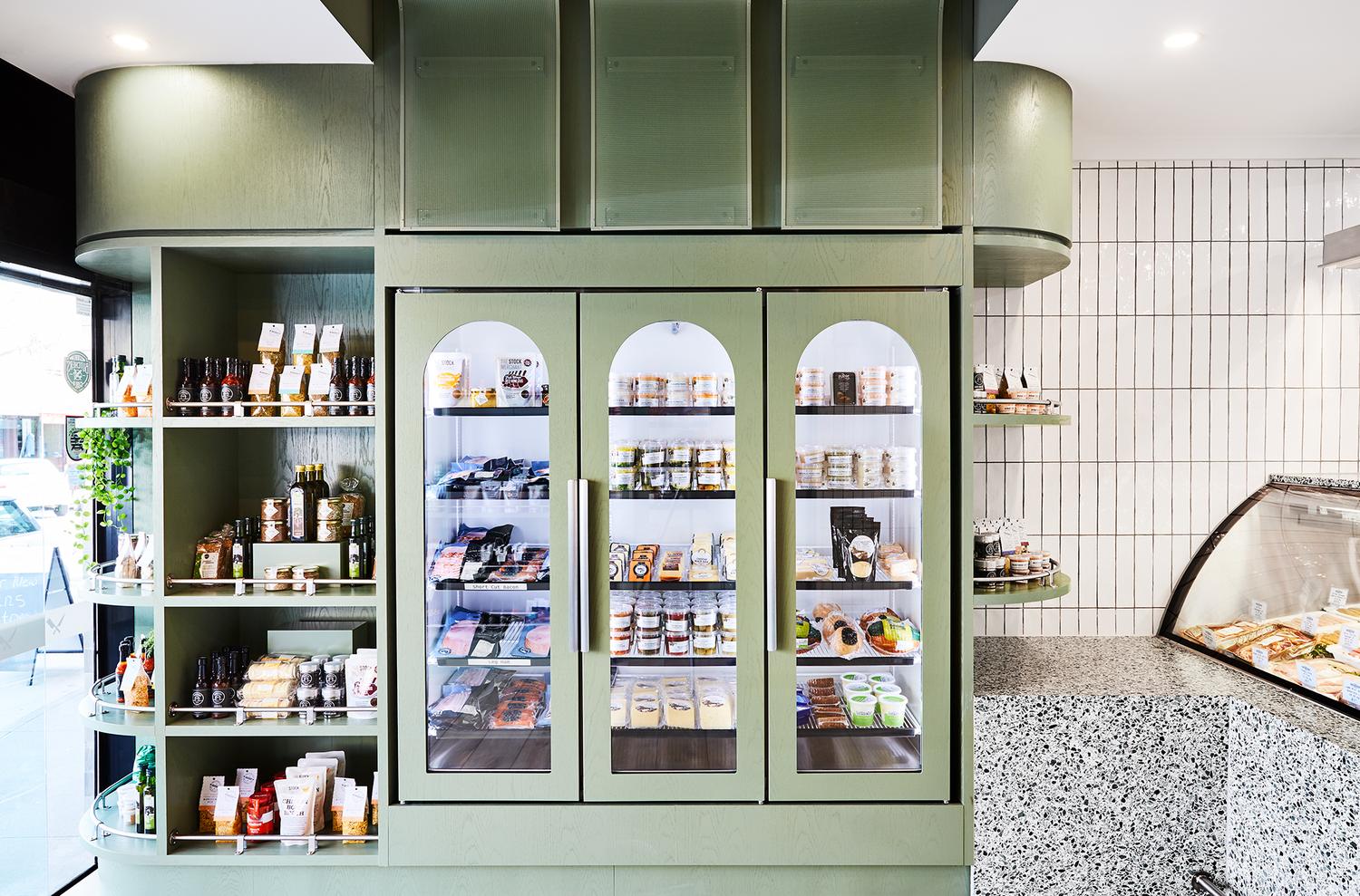 Inside the shop: the fridge cabinet, the pantry shelves and the counter.